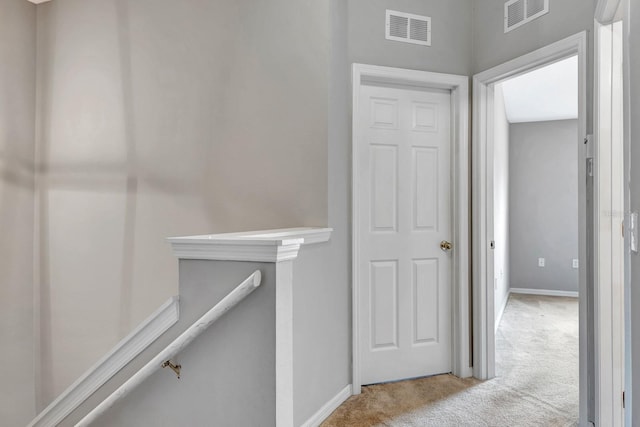 hallway featuring light carpet