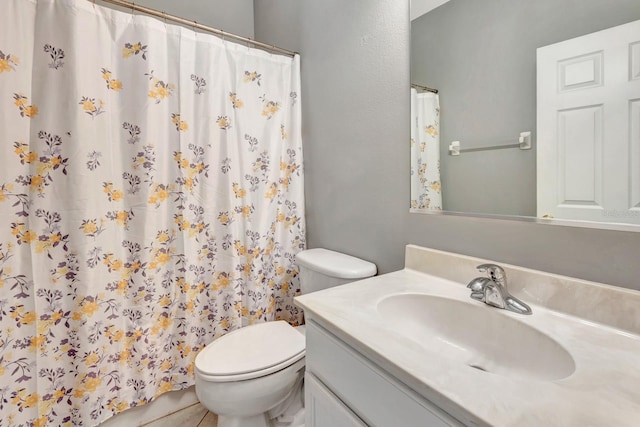 bathroom with toilet and vanity