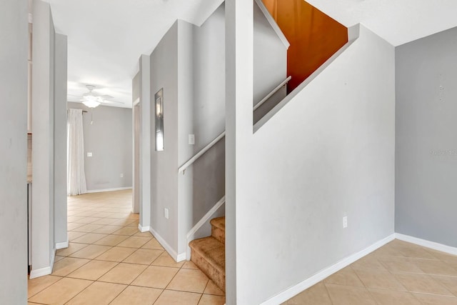 stairs with ceiling fan and tile patterned floors