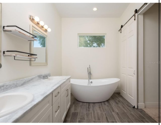 bathroom featuring a bath and vanity