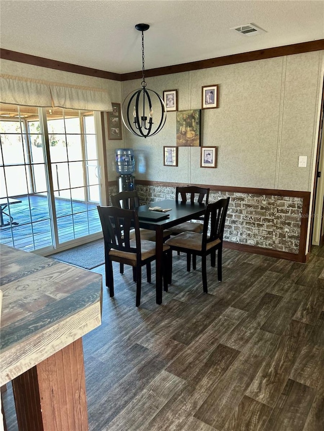 dining room featuring a textured ceiling, a notable chandelier, and dark hardwood / wood-style floors