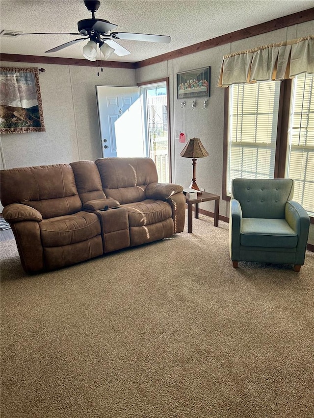 carpeted living room featuring a textured ceiling and ceiling fan