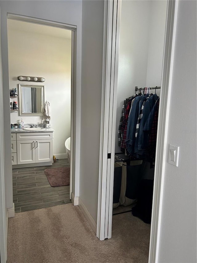 bathroom featuring vanity, hardwood / wood-style floors, and a bathing tub