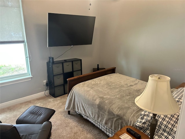 bedroom featuring light carpet