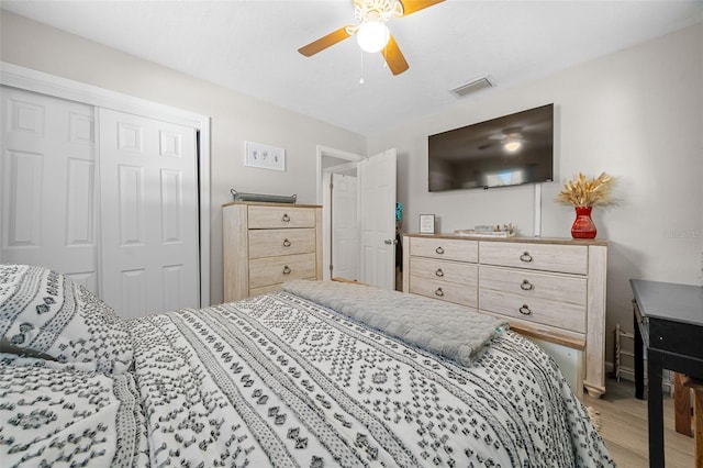 bedroom with a closet, ceiling fan, and hardwood / wood-style flooring