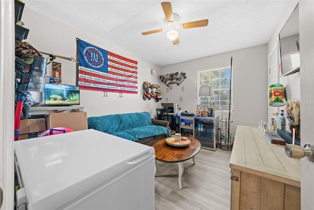 interior space with ceiling fan, light hardwood / wood-style flooring, and a textured ceiling