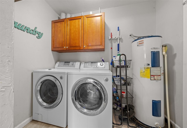 laundry area featuring washer and dryer, water heater, cabinets, and light hardwood / wood-style flooring