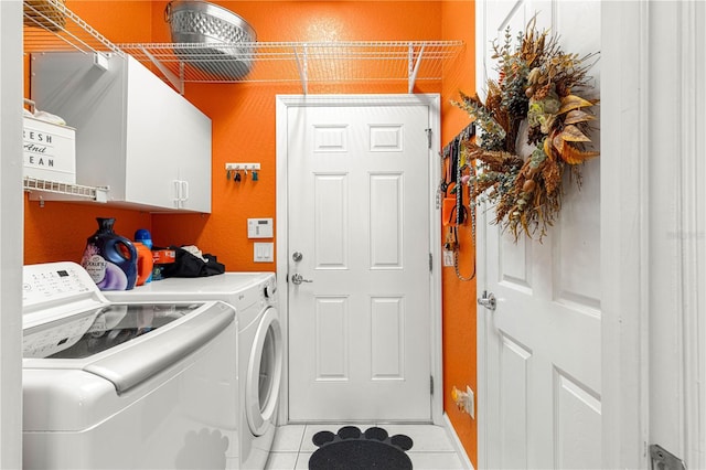 laundry room featuring light tile patterned floors, cabinets, and independent washer and dryer