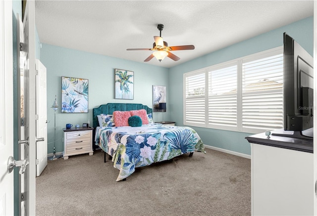 bedroom with light colored carpet, ceiling fan, and a textured ceiling