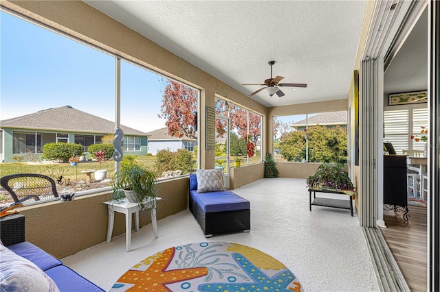 sunroom featuring ceiling fan