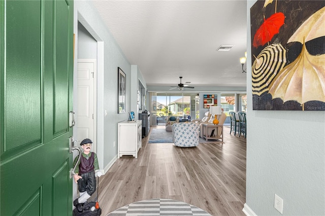 foyer featuring ceiling fan and light hardwood / wood-style flooring