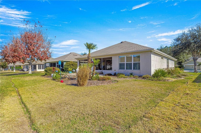 rear view of house featuring a yard