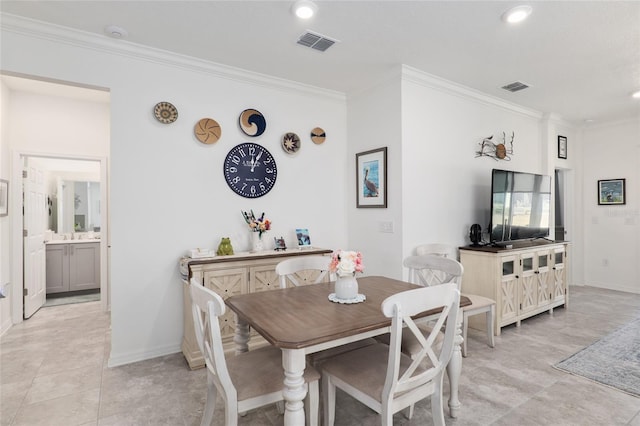 tiled dining area featuring crown molding