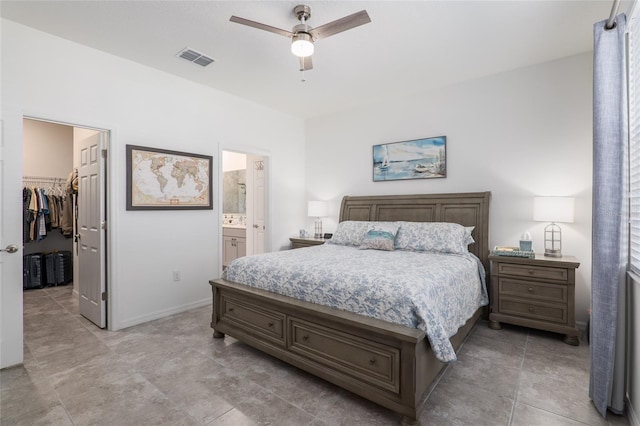 bedroom featuring connected bathroom, a spacious closet, a closet, and ceiling fan