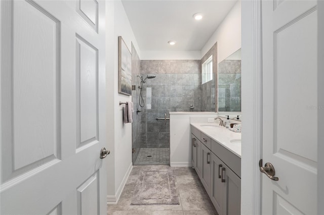 bathroom with vanity and a tile shower