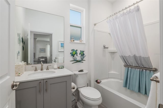 full bathroom featuring shower / bath combination with curtain, vanity, and toilet