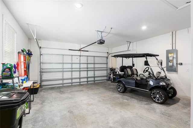 garage with a garage door opener and electric panel