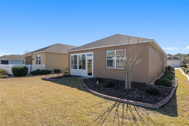 back of house with a lawn