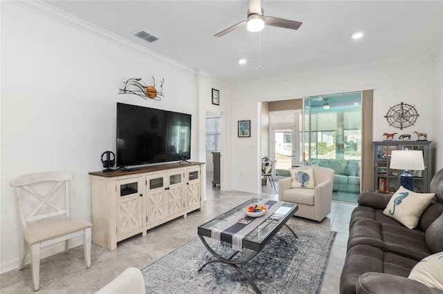 living room with ornamental molding, ceiling fan, and light tile patterned flooring