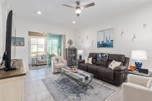 living room with ornamental molding, ceiling fan, and light tile patterned floors