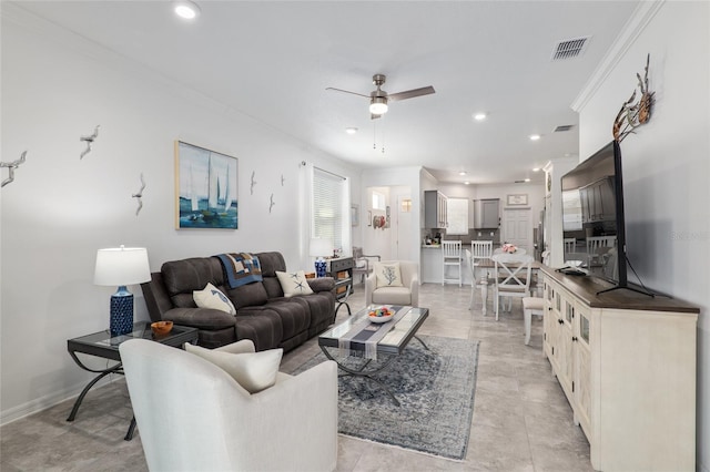 living room with ornamental molding and ceiling fan