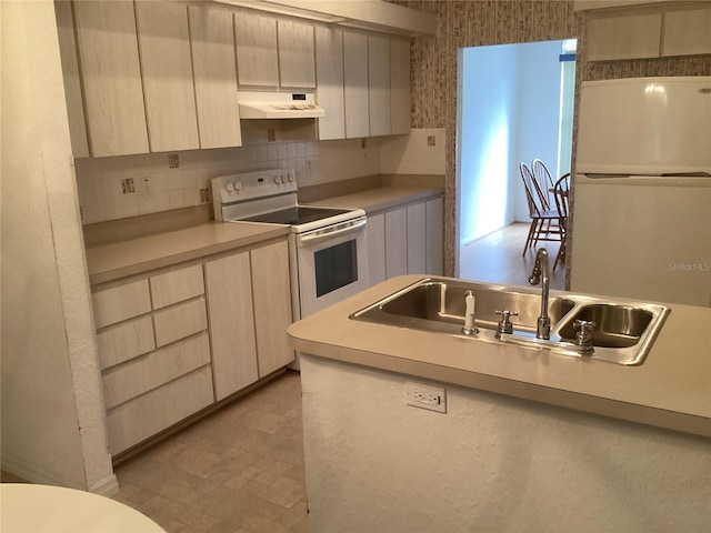 kitchen with sink, white appliances, and backsplash