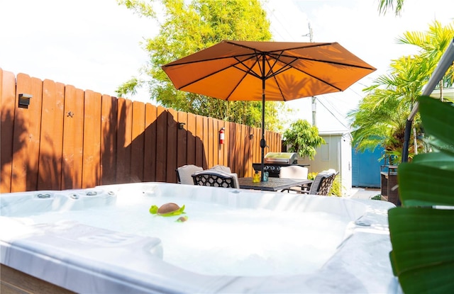 view of patio / terrace featuring a hot tub and area for grilling