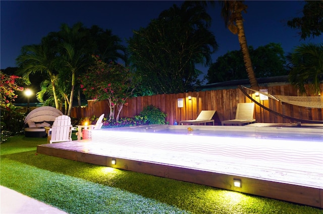 view of pool at night