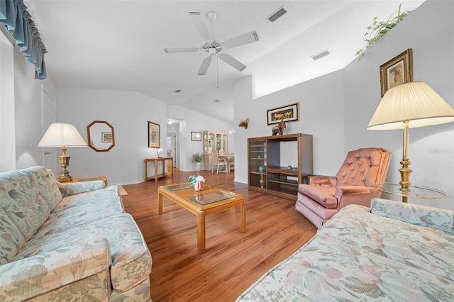 living room with vaulted ceiling, ceiling fan, and light hardwood / wood-style floors