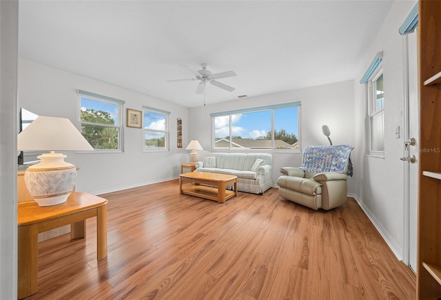 living room featuring ceiling fan and light hardwood / wood-style flooring