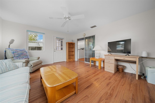 living room featuring ceiling fan and light hardwood / wood-style flooring