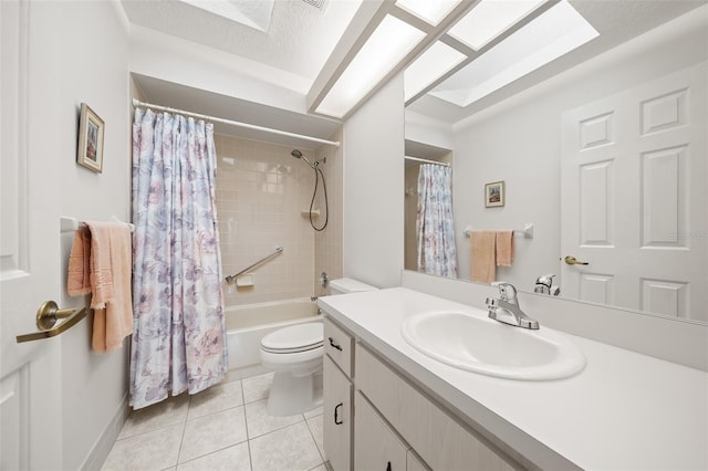 full bathroom featuring shower / bath combination with curtain, toilet, vanity, tile patterned floors, and a textured ceiling