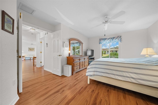 bedroom with ceiling fan and light hardwood / wood-style flooring