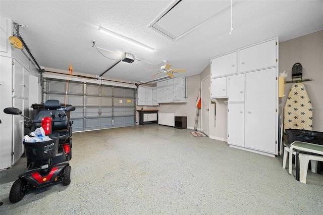 garage with ceiling fan and a garage door opener