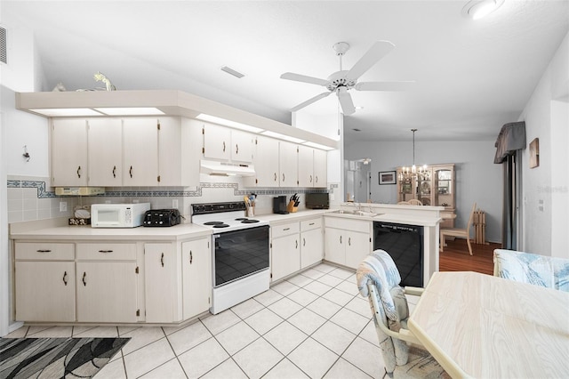 kitchen with white appliances, hanging light fixtures, decorative backsplash, ceiling fan with notable chandelier, and sink