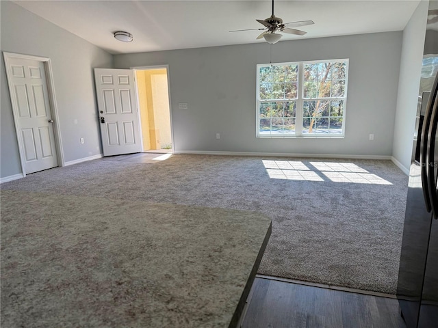 spare room featuring ceiling fan and carpet flooring