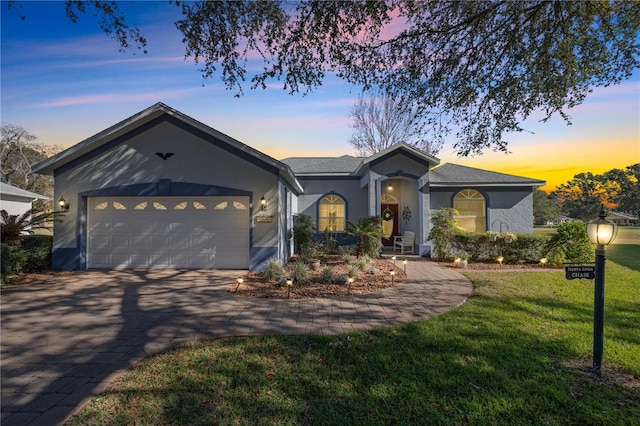 view of front of house featuring a lawn and a garage