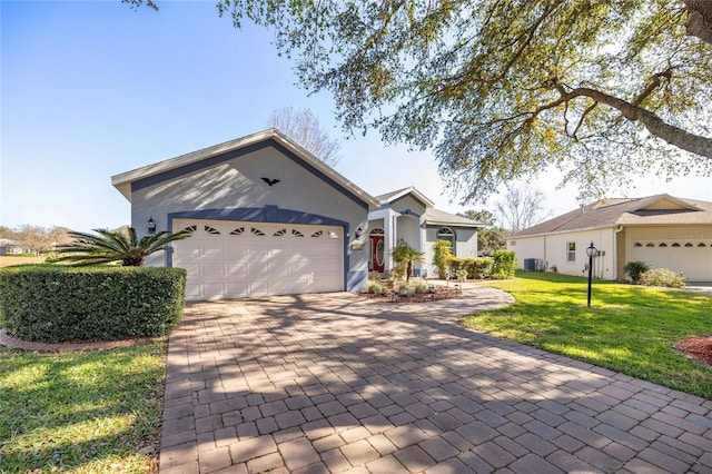 ranch-style house featuring a garage and a front lawn