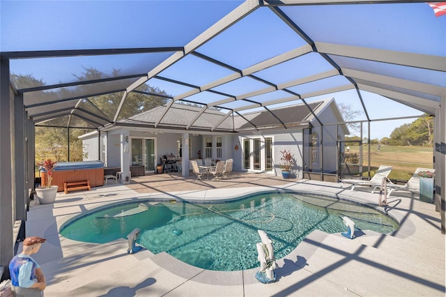 view of pool featuring french doors, a patio area, glass enclosure, and a hot tub