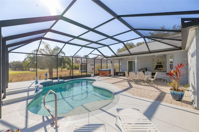 view of swimming pool with a patio area, a hot tub, ceiling fan, and glass enclosure