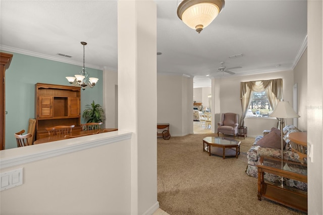 interior space with ceiling fan with notable chandelier, carpet floors, and crown molding