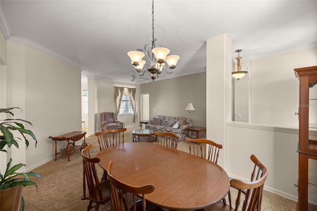 dining room with crown molding, a chandelier, and carpet