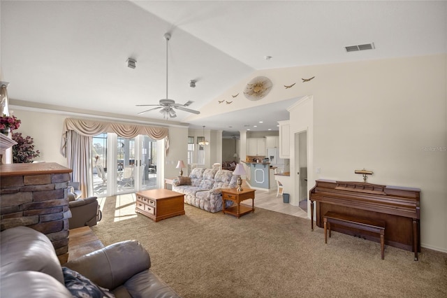 living room featuring vaulted ceiling, ceiling fan, and light carpet