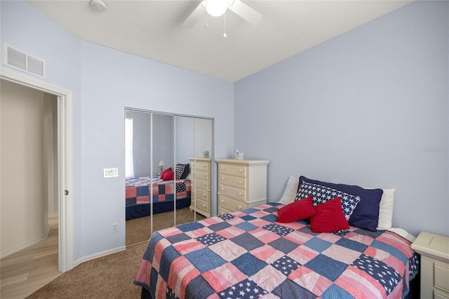 bedroom with ceiling fan, a closet, and carpet flooring