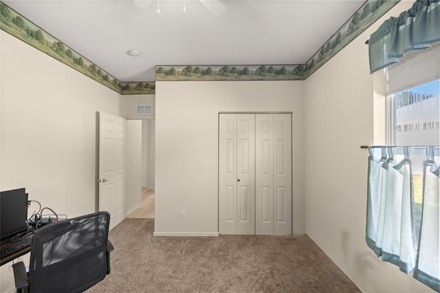 office with light carpet and ceiling fan