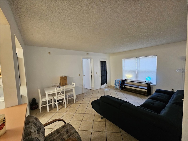 living room featuring light tile patterned flooring and a textured ceiling