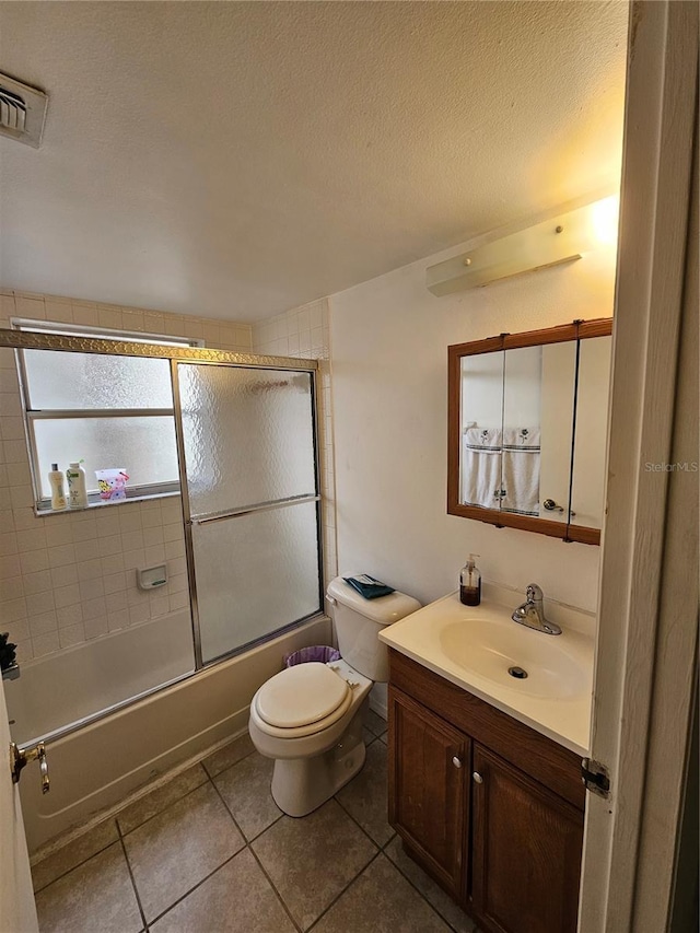 full bathroom with toilet, enclosed tub / shower combo, tile patterned floors, vanity, and a textured ceiling