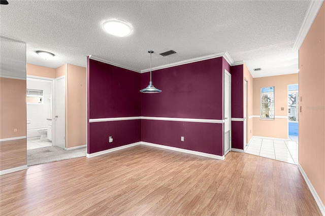 unfurnished room with wood-type flooring, ornamental molding, and a textured ceiling