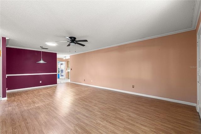 empty room with hardwood / wood-style flooring, a textured ceiling, crown molding, and ceiling fan