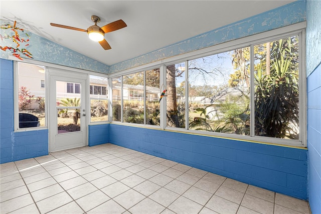 unfurnished sunroom with vaulted ceiling, ceiling fan, and a wealth of natural light